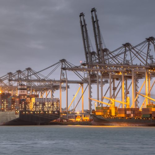 Cargo carrier ships loaded in Rotterdam Maasvlakte container terminal at sunset. The Netherlands